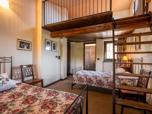 a bedroom with two beds and a loft at Holiday Home General Massena - NAZ111 by Interhome in Bene Vagienna