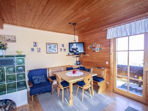 a dining room with a table and chairs and a television at Chalet Willegger by Interhome in Hochrindl