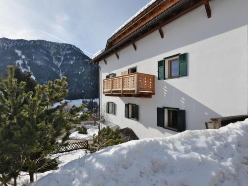 a building with a balcony in the snow at Apartment Luca by Interhome in Ortisei