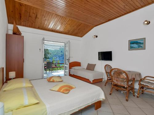 a bedroom with two beds and a living room at Apartment Martina by Interhome in Selca kod Bogomolja