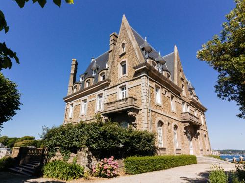 a large stone building with a turret at Apartment Château des Deux Rives by Interhome in Dinard