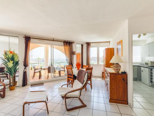 a living room with a table and chairs at Apartment Bleu Marine-5 by Interhome in Fréjus