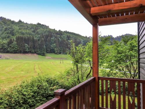 a porch of a house with a view of a field at Apartment Spatzennest - Top 7 by Interhome in Grünau im Almtal