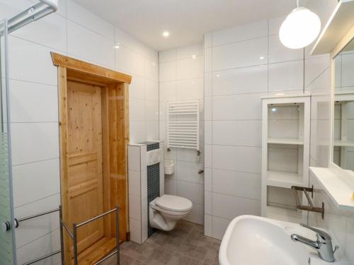 a white bathroom with a toilet and a sink at Apartment Bärenhöhle - Top 6 by Interhome in Grünau im Almtal