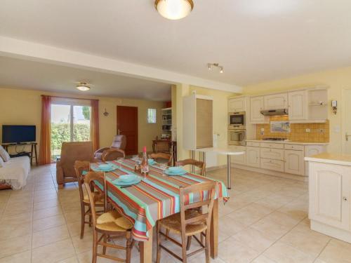 a kitchen and living room with a table and chairs at Holiday Home Maison Les Hortensias by Interhome in Pleurtuit