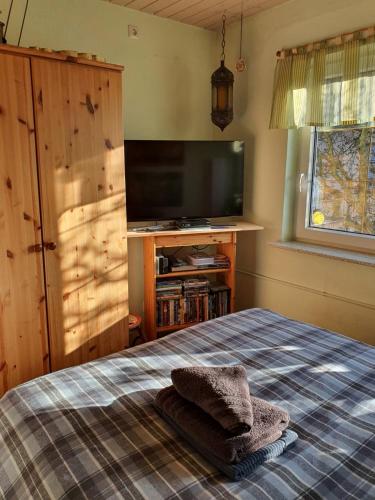 a bedroom with a bed and a flat screen tv at Luxus Ferienwohnung in Pfungstadt