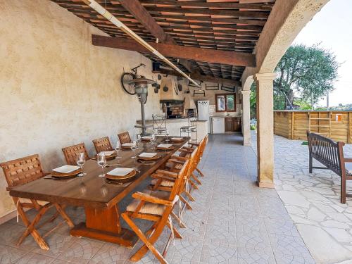 a large wooden table and chairs on a patio at Holiday Home Nicoleine by Interhome in Cagnes-sur-Mer