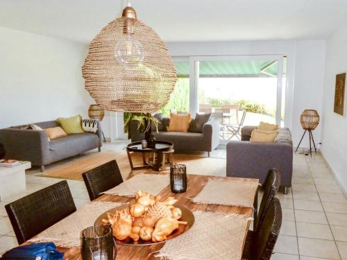 a living room with a table and a dining room at Villa Bellevue by Interhome in Grandvaux