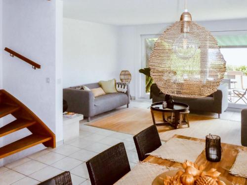 a living room with a table and a chandelier at Villa Bellevue by Interhome in Grandvaux