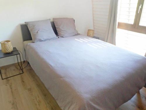 a large white bed in a room with a window at Villa Bellevue by Interhome in Grandvaux