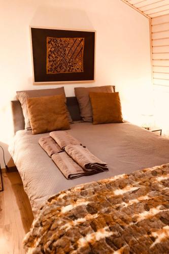 a bed with pillows and a blanket on it at Villa Bellevue by Interhome in Grandvaux
