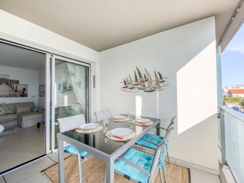 a dining room with a table and chairs at Apartment Le Newport-2 by Interhome in Fréjus