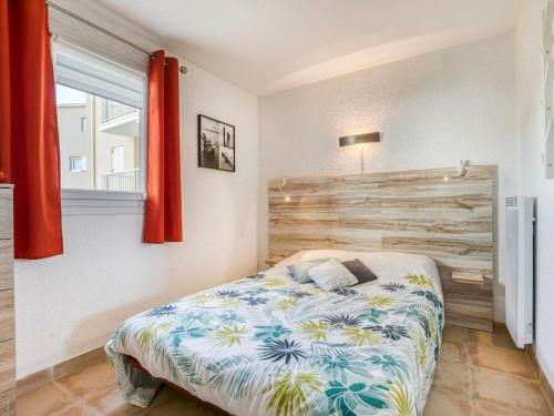 une chambre avec un lit et un mur en bois dans l'établissement Apartment Les Saladelles-10 by Interhome, au Grau-du-Roi