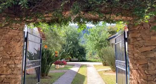 an entrance to a garden with an iron gate at Pousada Pe da Serra in Tiradentes
