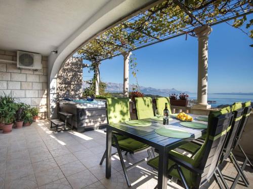 a patio with a table and chairs and a grill at Holiday Home Ivana by Interhome in Selca