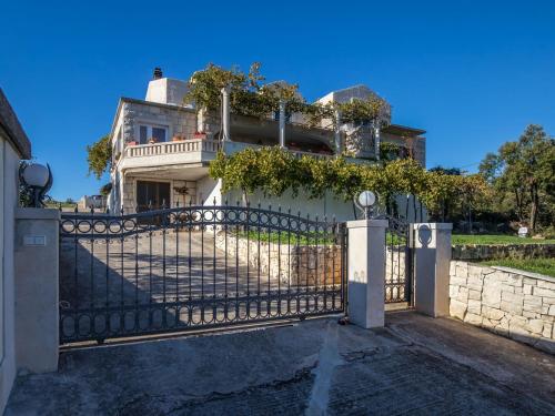 a fence in front of a house at Holiday Home Ivana by Interhome in Selca
