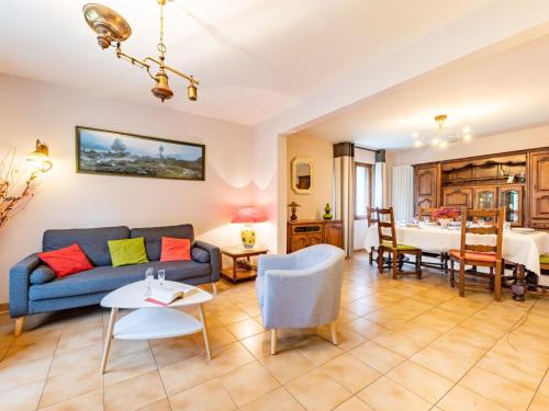 a living room with a couch and a table at Holiday Home Coët A Tous by Interhome in Carnac