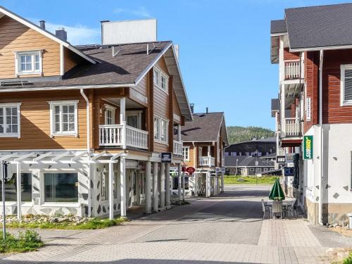 a row of wooden houses on a street at Holiday Home Aquahovi b5 by Interhome in Sirkka