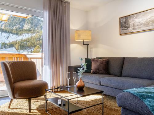 a living room with a couch and a table at Apartment Verena by Interhome in Kandersteg