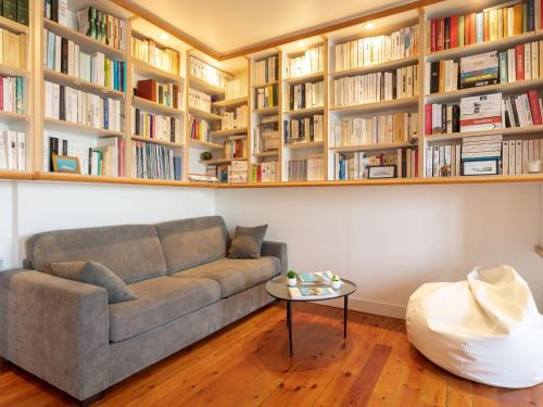 a living room with a couch and bookshelves at Apartment Ker Louis 2 by Interhome in Dinard