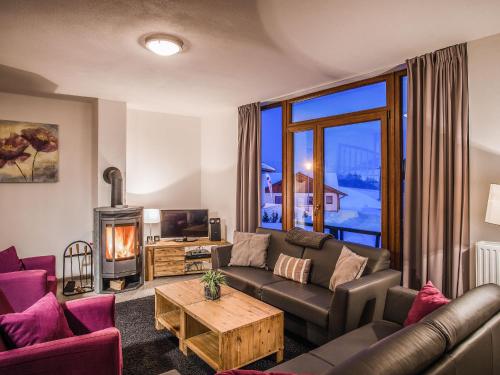a living room with a couch and a fireplace at Holiday Home Residence Lipno-1 by Interhome in Lipno nad Vltavou