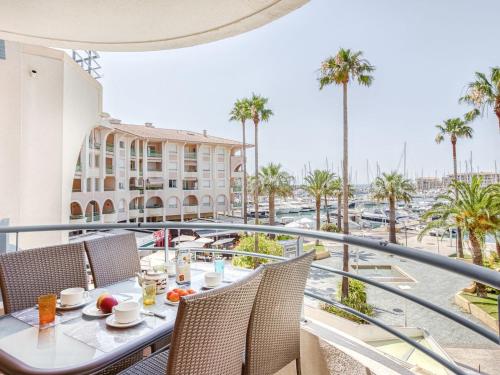un balcon avec une table et des chaises et une vue sur un port dans l'établissement Apartment Royal Marine-5 by Interhome, à Fréjus
