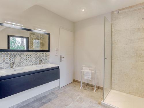 a bathroom with a tub and a sink and a shower at Holiday Home L'allée Couverte by Interhome in La Trinité-sur-Mer