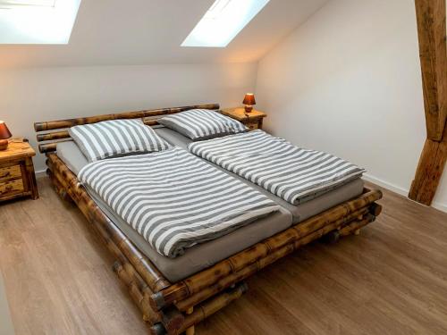 a large bed with two pillows on it in a room at Apartment Borkum by Interhome in Westerholt