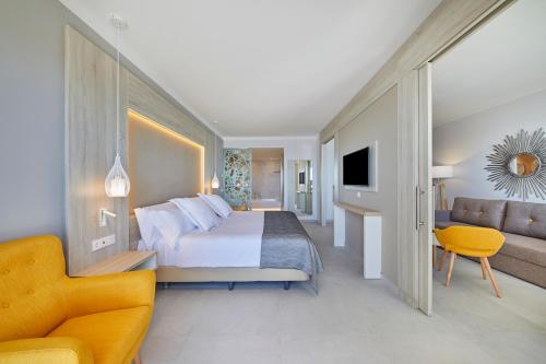 a hotel room with a bed and a couch at Bahia Principe Fantasia Tenerife - All Inclusive in San Miguel de Abona