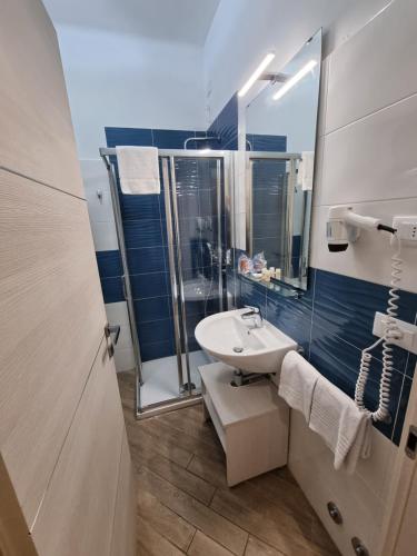 a bathroom with a sink, toilet and bathtub at Palafiori Rooms Sanremo in Sanremo