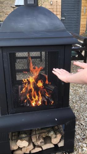 a person is standing in front of a fireplace at The Bridge House in Bridport