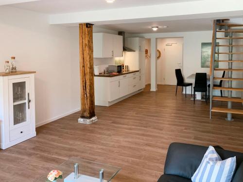 een woonkamer met een bank en een tafel en een keuken bij Apartment Langeoog by Interhome in Westerholt