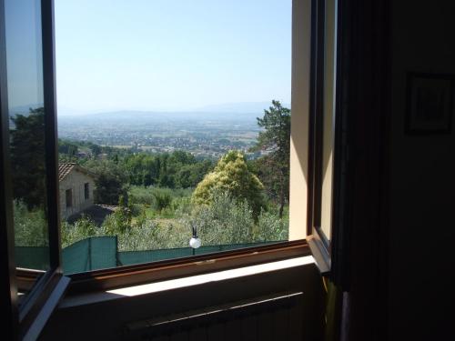 a window with a view of a city at Camere Ramaccia in Assisi