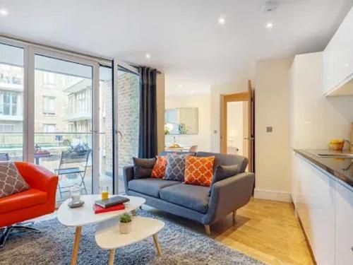 a living room with a couch and a table at Apartment Canary Gateway- Canary Wharf by Interhome in London