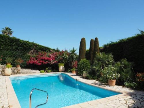a swimming pool in a garden with plants at Villa Belvedere by Interhome in Mougins