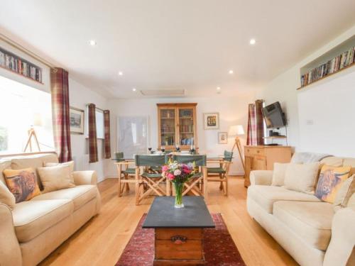 a living room with a couch and a table at Holiday Home Easdale Cottage by Interhome in Oban