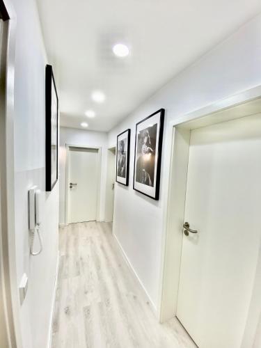 a hallway with white walls and a white door at Living Solution 24 Karlsruhe in Karlsruhe