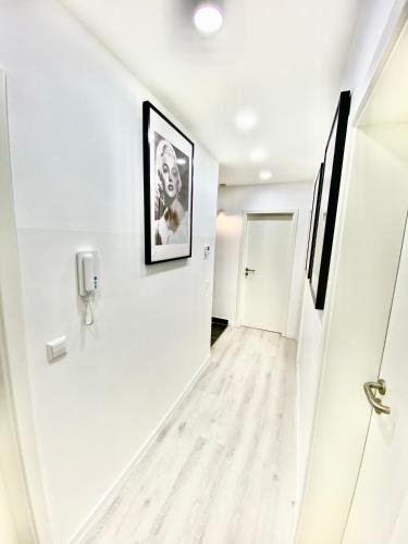 a hallway with white walls and a picture on the wall at Living Solution 24 Karlsruhe in Karlsruhe