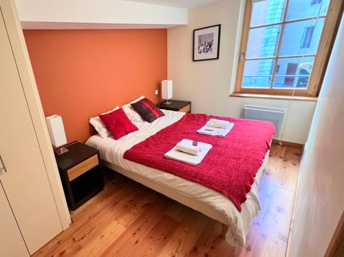 - une chambre avec un grand lit et une couverture rouge dans l'établissement T2 au cœur du centre historique de Briançon #5, à Briançon
