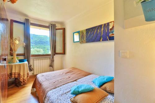 a small bedroom with a bed and a window at LOCATIONS-06 La Maison de Noelie garden floor in Le Bar-sur-Loup