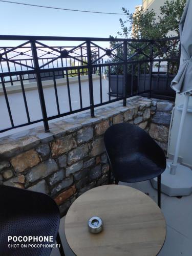 a table and two chairs on a balcony at Minois Boutique Hotel in Stalida