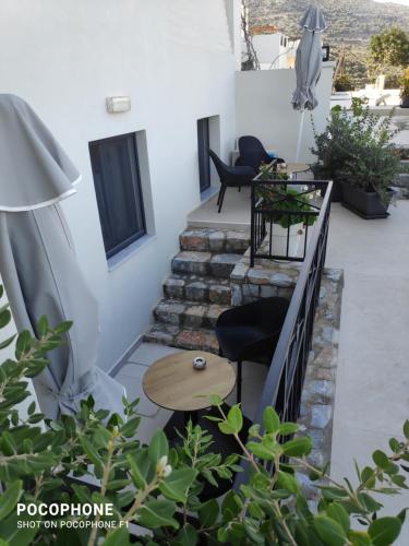 a patio with stairs and a table and chairs at Minois Boutique Hotel in Stalida