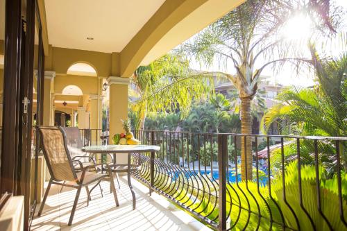 a patio with a table and chairs on a balcony at Monte Carlo Luxury Condominiums in Jacó