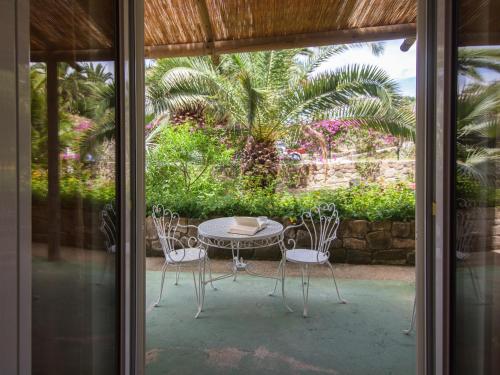 a patio with a table and chairs and a table at Semiramis Hotel De Charme & Pools in Ischia