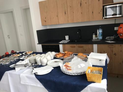 a table with a blue table cloth with food on it at Mimi Leuca B&b in Leuca