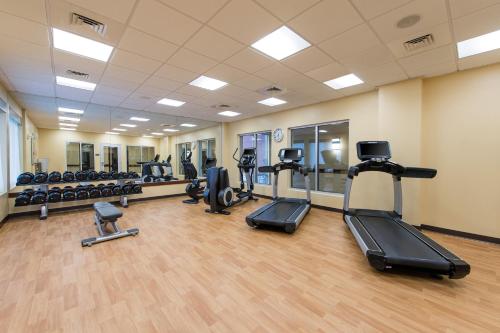 a gym with treadmills and ellipticals in a room at Hyatt Place Charleston Airport / Convention Center in Charleston