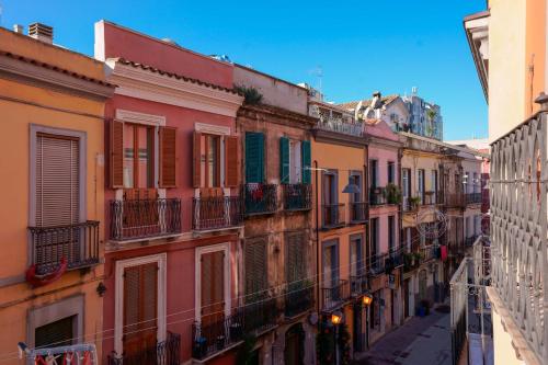 a row of buildings with balconies on a street at Sa Domu Cheta in Cagliari