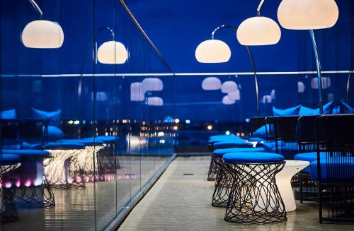 a room with chairs and tables and lights at Genting Hotel & Spa at Resorts World Birmingham in Bickenhill