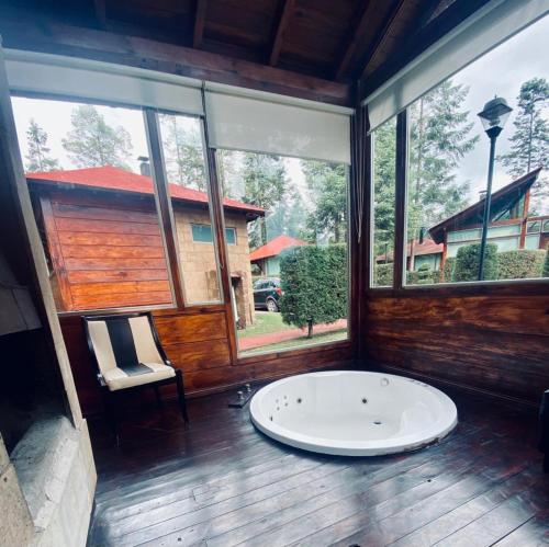 a large room with a large window and a bath tub at Quinta Los Azufres in Los Azufres