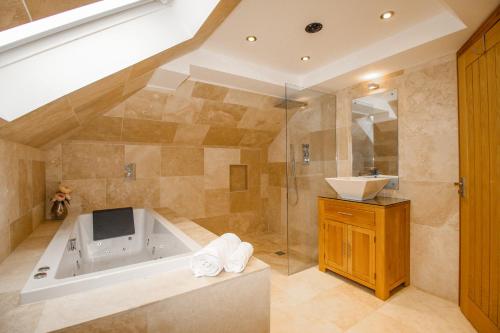a large bathroom with a tub and a sink at Family House in Weymouth